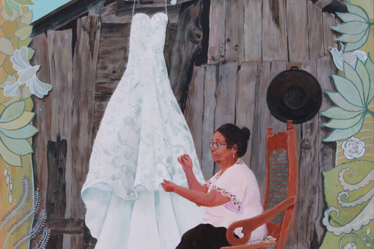 Woman sewing wedding dress, Mexican mother in law sewing wedding dress, woman in rocking chair, mother in law portrait, painted flower boarder, portrait of older woman